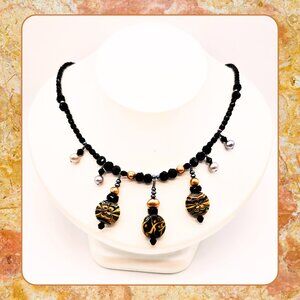 Artisan Black Bead Necklace with Gold Swirl Lucite Dangle Beads
